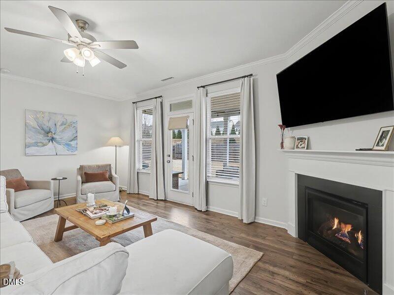 724 Summer Music Lane Raleigh, NC 27603 - Photo 22 of 70 a living room with furniture a flat screen tv and a fireplace