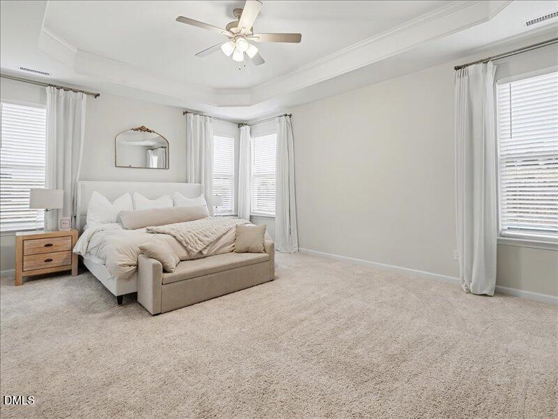 724 Summer Music Lane Raleigh, NC 27603 - Photo 26 of 70 a spacious bedroom with a bed and a chandelier