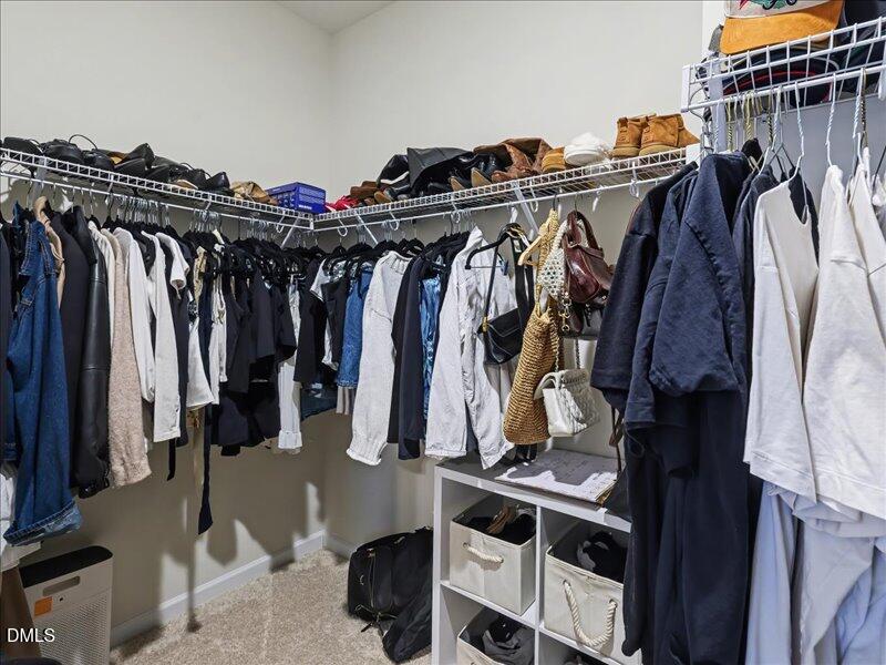 724 Summer Music Lane Raleigh, NC 27603 - Photo 32 of 70 a view of walk in closet with clothes and shoes