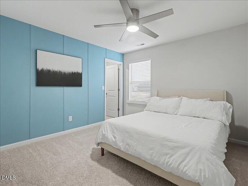 724 Summer Music Lane Raleigh, NC 27603 - Photo 46 of 70 a bedroom with a large bed and a flat screen tv