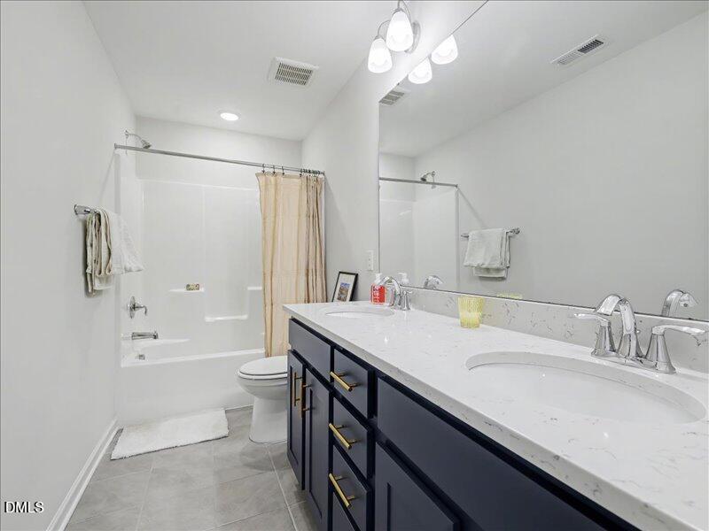 724 Summer Music Lane Raleigh, NC 27603 - Photo 47 of 70 a bathroom with a granite countertop sink a toilet a large mirror and shower
