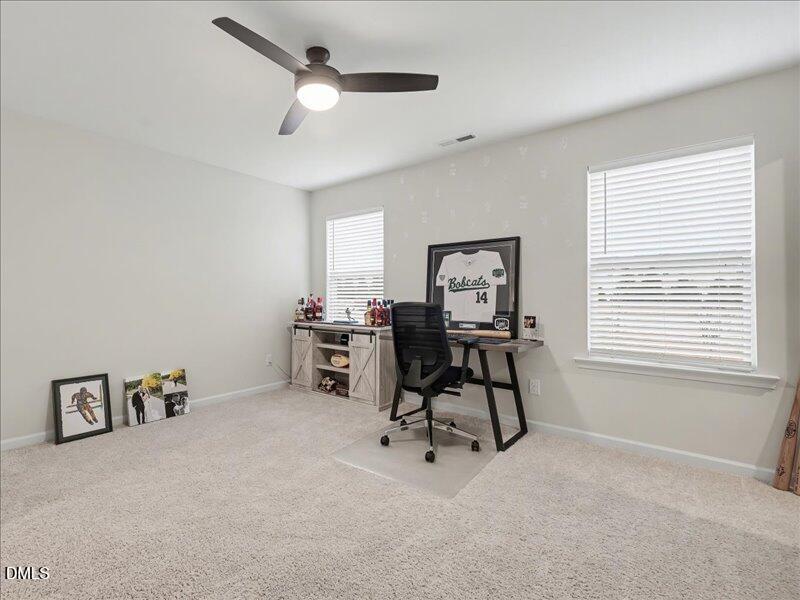 724 Summer Music Lane Raleigh, NC 27603 - Photo 49 of 70 a view of a workspace with furniture and a window