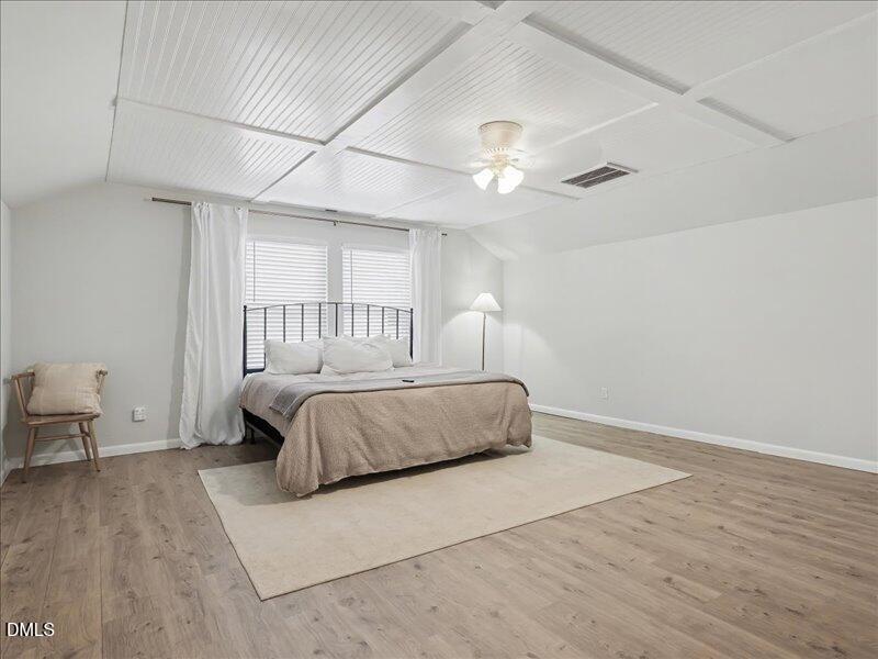 724 Summer Music Lane Raleigh, NC 27603 - Photo 50 of 70 a bedroom with a large bed and a chandelier