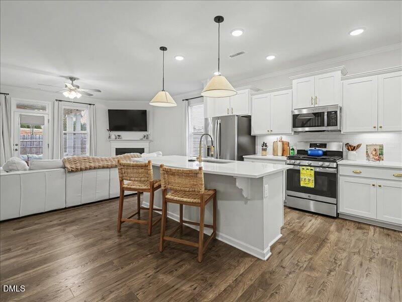 724 Summer Music Lane Raleigh, NC 27603 - Photo 70 of 70 a kitchen with kitchen island granite countertop a sink counter top space appliances and a center island