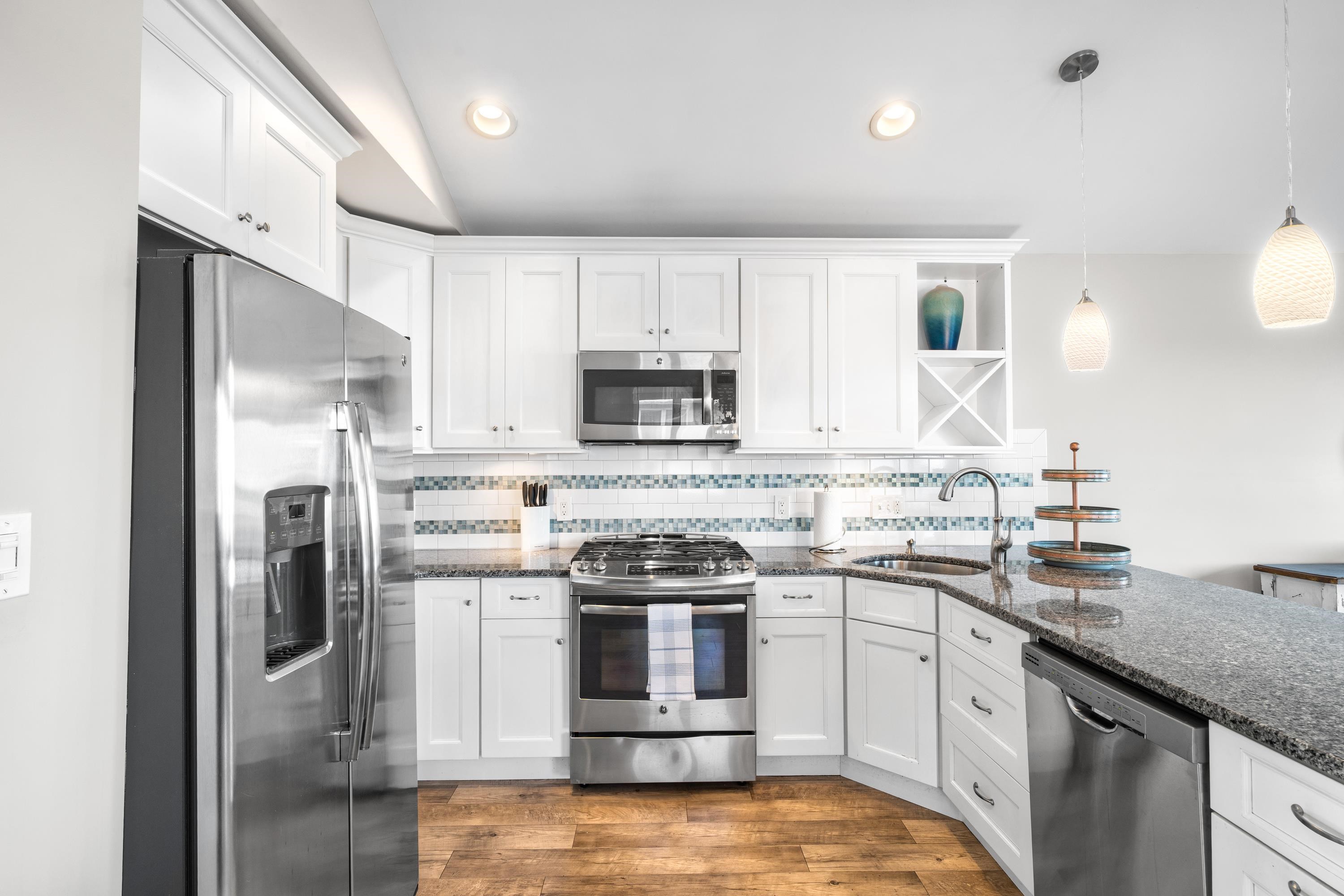 2934 Ocean Drive, Unit NORTH Avalon, NJ 08202 - Photo 13 of 33 a kitchen with stainless steel appliances granite countertop a stove a sink and a refrigerator