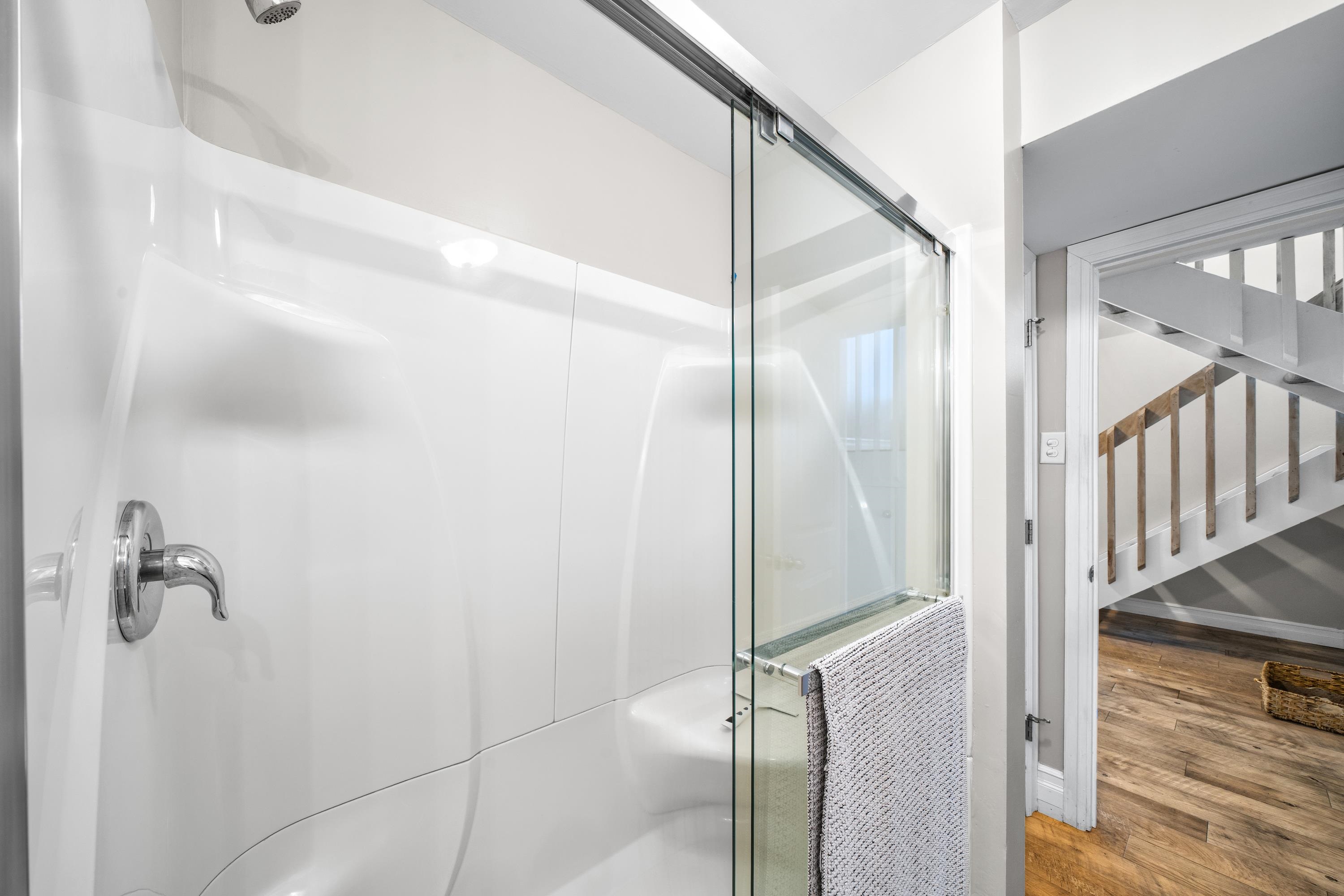 2934 Ocean Drive, Unit NORTH Avalon, NJ 08202 - Photo 23 of 33 a bathroom with a shower and a glass door