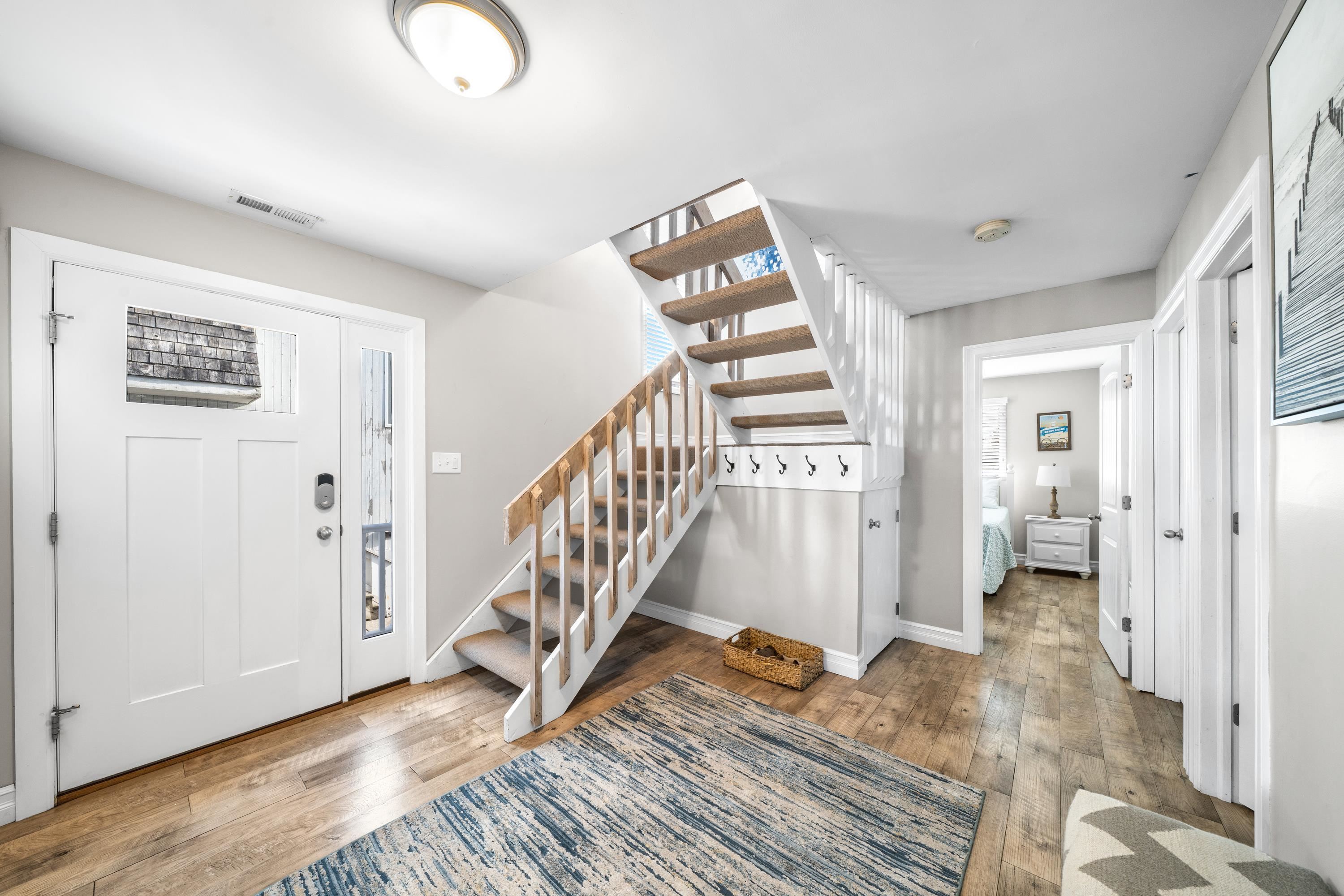 2934 Ocean Drive, Unit NORTH Avalon, NJ 08202 - Photo 27 of 33 a view of a hallway with wooden floor and staircase