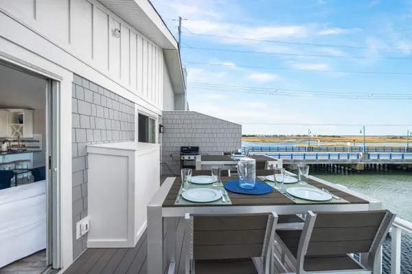 a view of a roof deck with chair and wooden floor