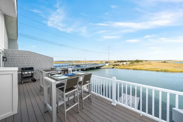 a view of a balcony with furniture and wooden floor