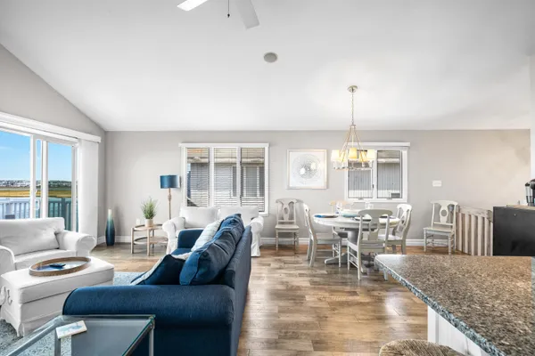 a living room with kitchen island furniture and a kitchen view