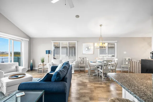a living room with kitchen island furniture and a kitchen view