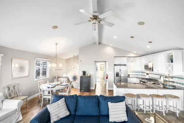 a view of a dining room with furniture wooden floor and a chandelier