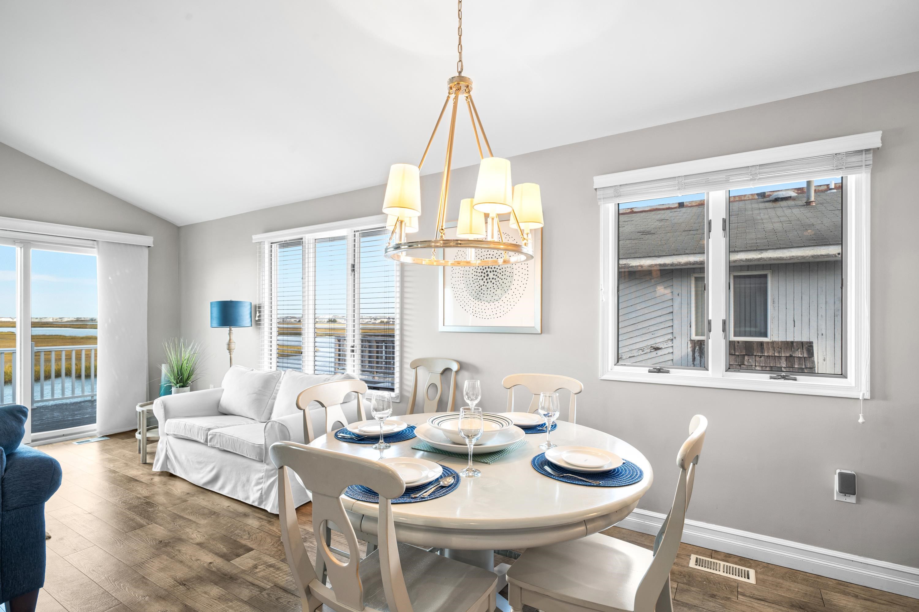 2934 Ocean Drive, Unit NORTH Avalon, NJ 08202 - Photo 10 of 33 a view of a dining room with furniture wooden floor and a chandelier
