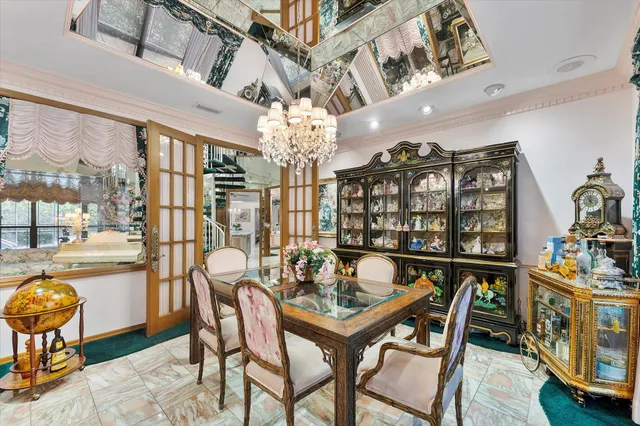 a kitchen with granite countertop a sink and a white wooden cabinets