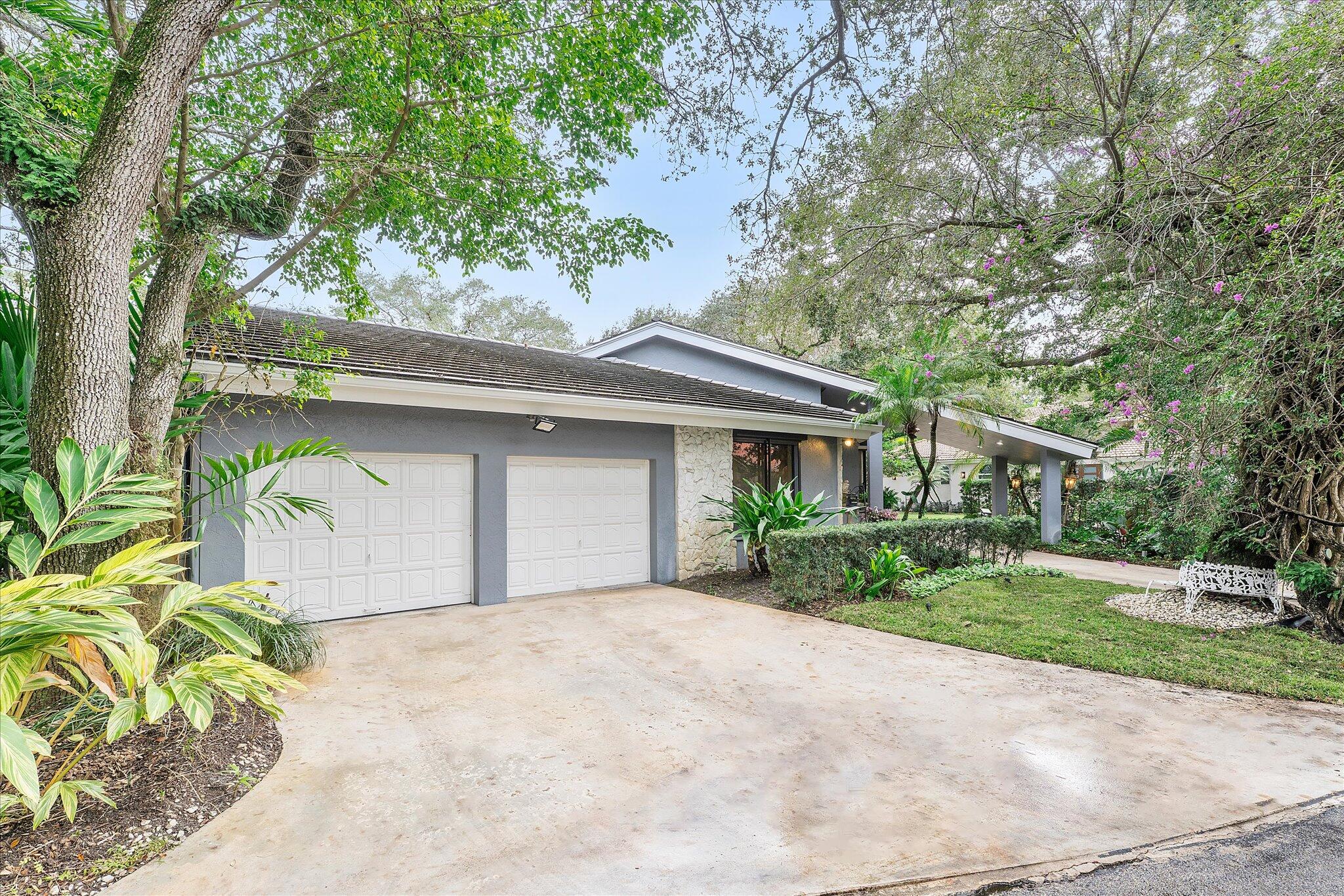 3333 Southwest 59th Street Fort Lauderdale, FL 33312 - Photo 2 of 56 a front view of a house with a garden and trees