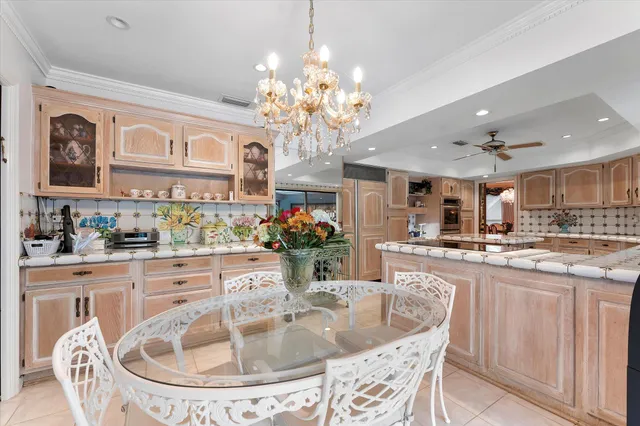 a dining room with furniture a chandelier and wooden floor