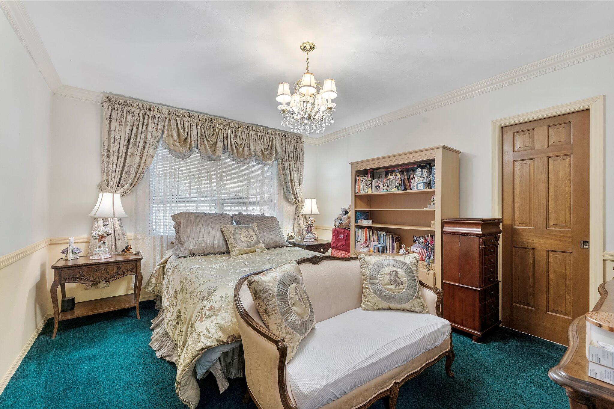 3333 Southwest 59th Street Fort Lauderdale, FL 33312 - Photo 29 of 56 a bedroom with a bed and a chandelier