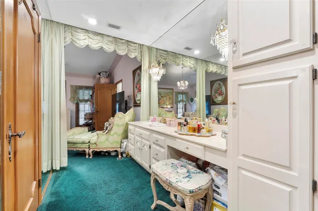 a bathroom with a sink a toilet a mirror and shower