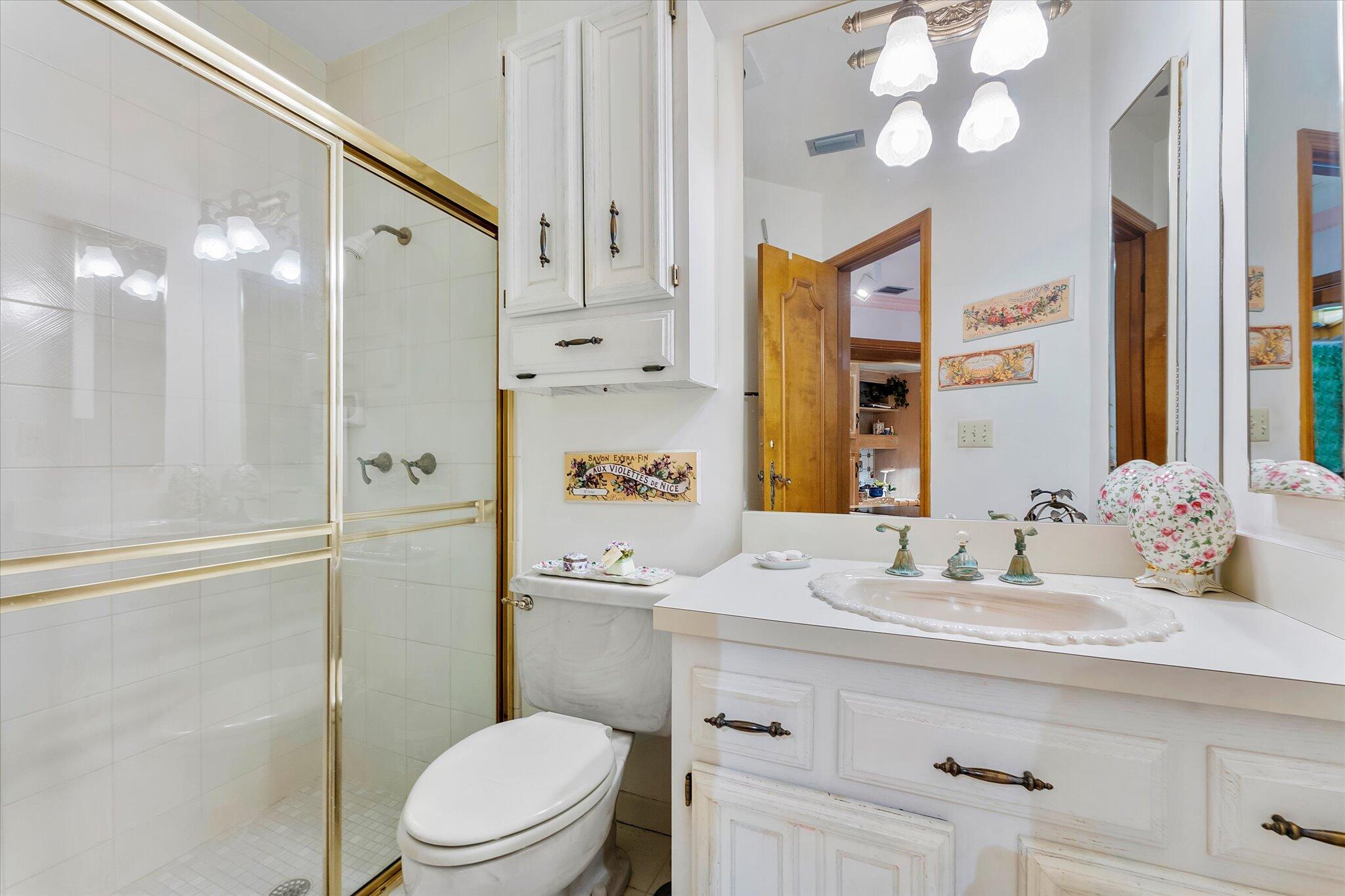 3333 Southwest 59th Street Fort Lauderdale, FL 33312 - Photo 46 of 56 a bathroom with a sink a toilet a mirror and shower