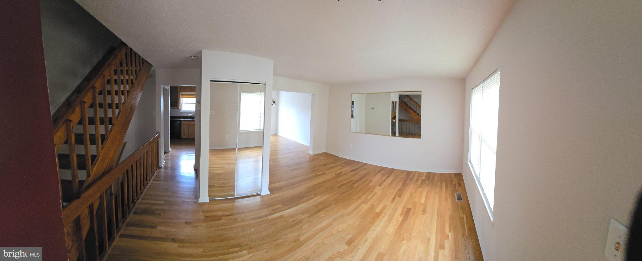 809 St Michaels Drive Bowie, MD 20721 - Photo 2 of 17 a view of a hallway with wooden floor and staircase