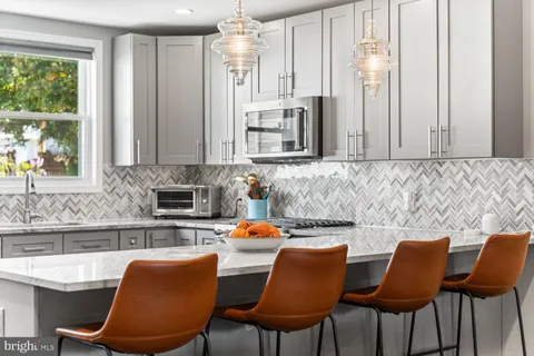 a kitchen with stainless steel appliances granite countertop a sink and a white cabinets