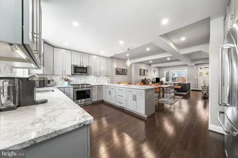 a kitchen with a sink cabinets and wooden floor
