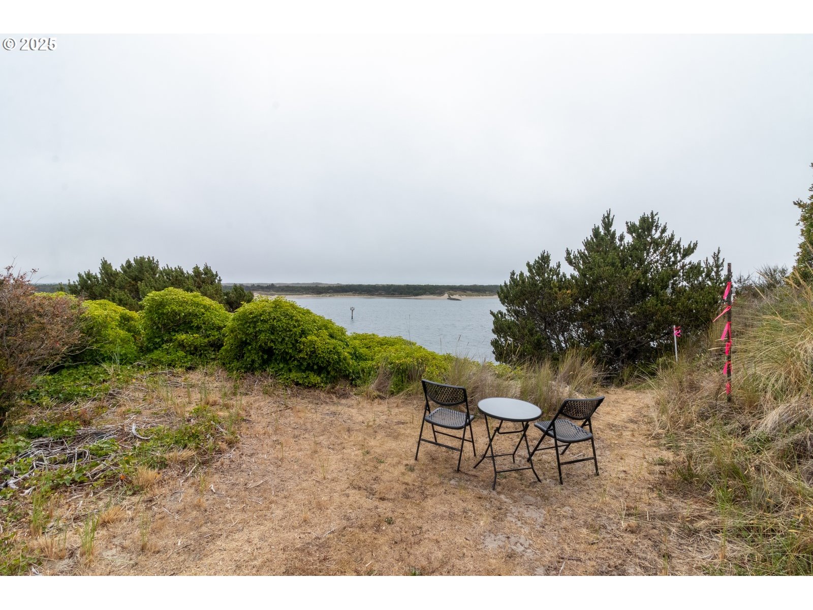 2 Eden Lane Florence, OR 97439 - Photo 13 of 48 a backyard of a house with table and chairs