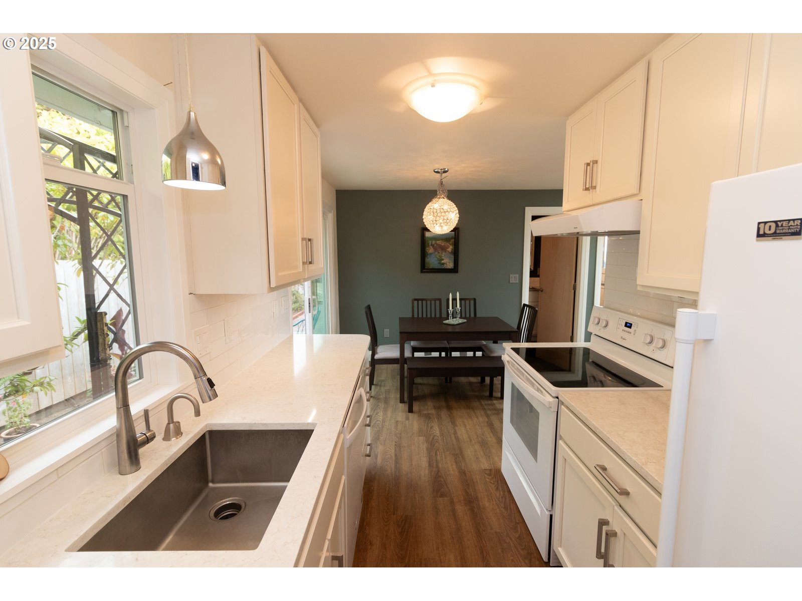 2 Eden Lane Florence, OR 97439 - Photo 28 of 48 a kitchen that has a sink and a stove top oven with wooden floor
