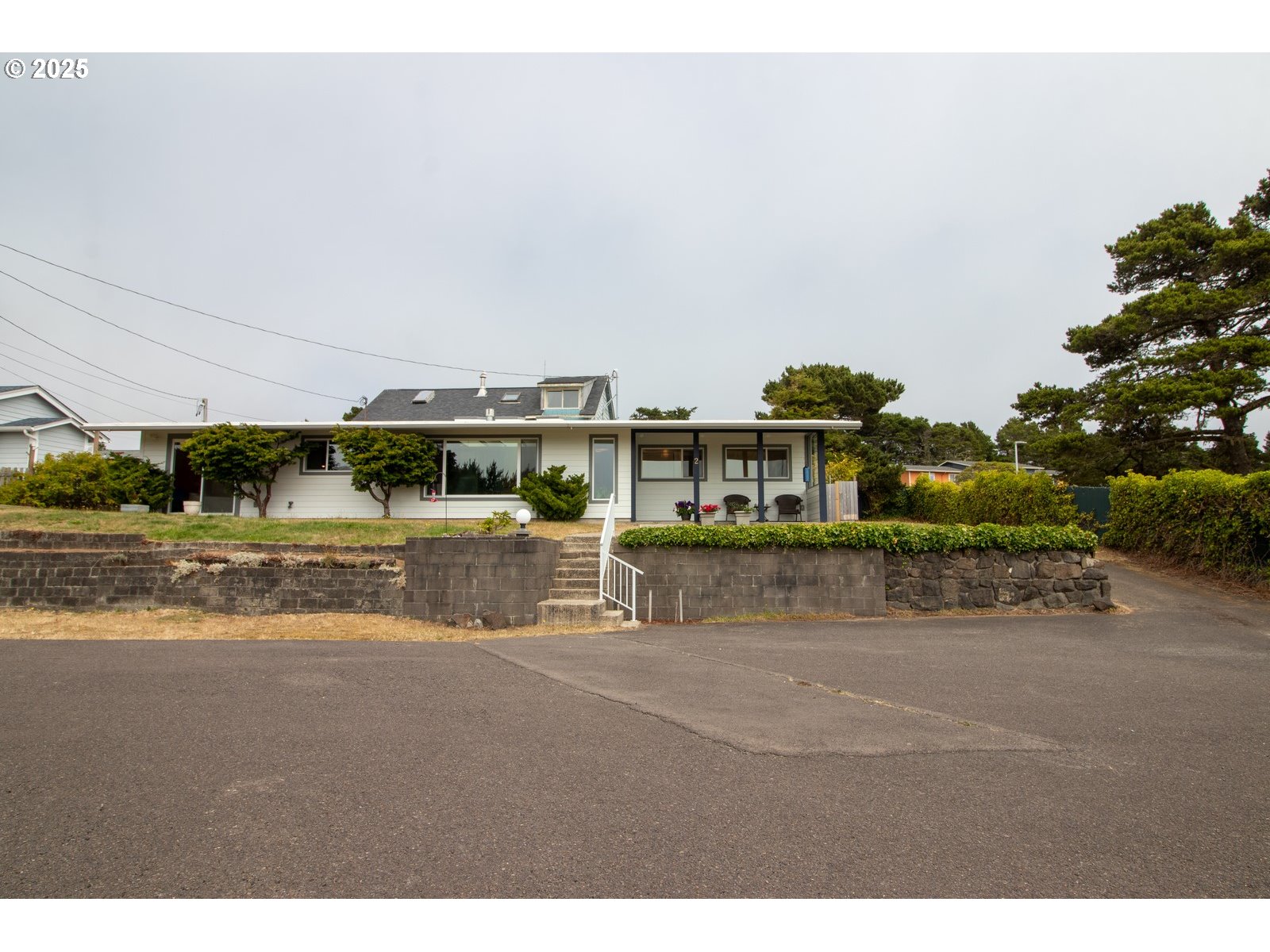 2 Eden Lane Florence, OR 97439 - Photo 5 of 48 a view of building with river and trees in the background
