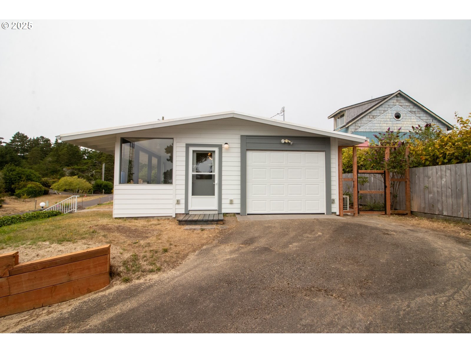 2 Eden Lane Florence, OR 97439 - Photo 8 of 48 a view of a house with backyard and trees