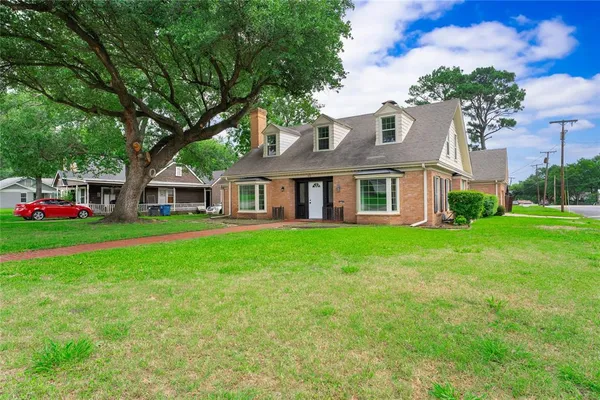 a front view of house with yard and green space