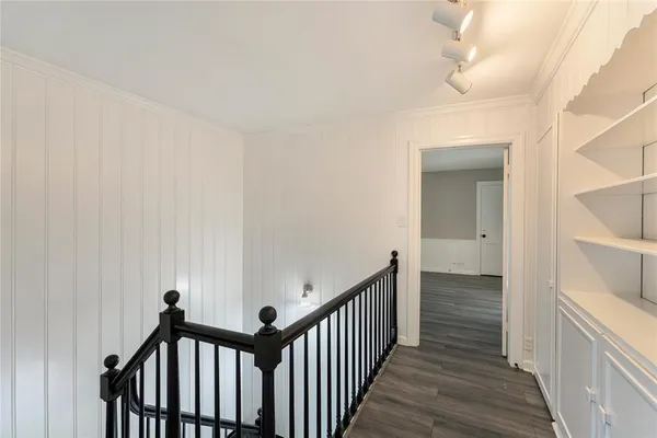 a view of a hallway with wooden floor and entryway