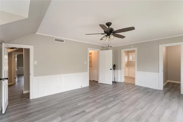 a view of empty room with wooden floor
