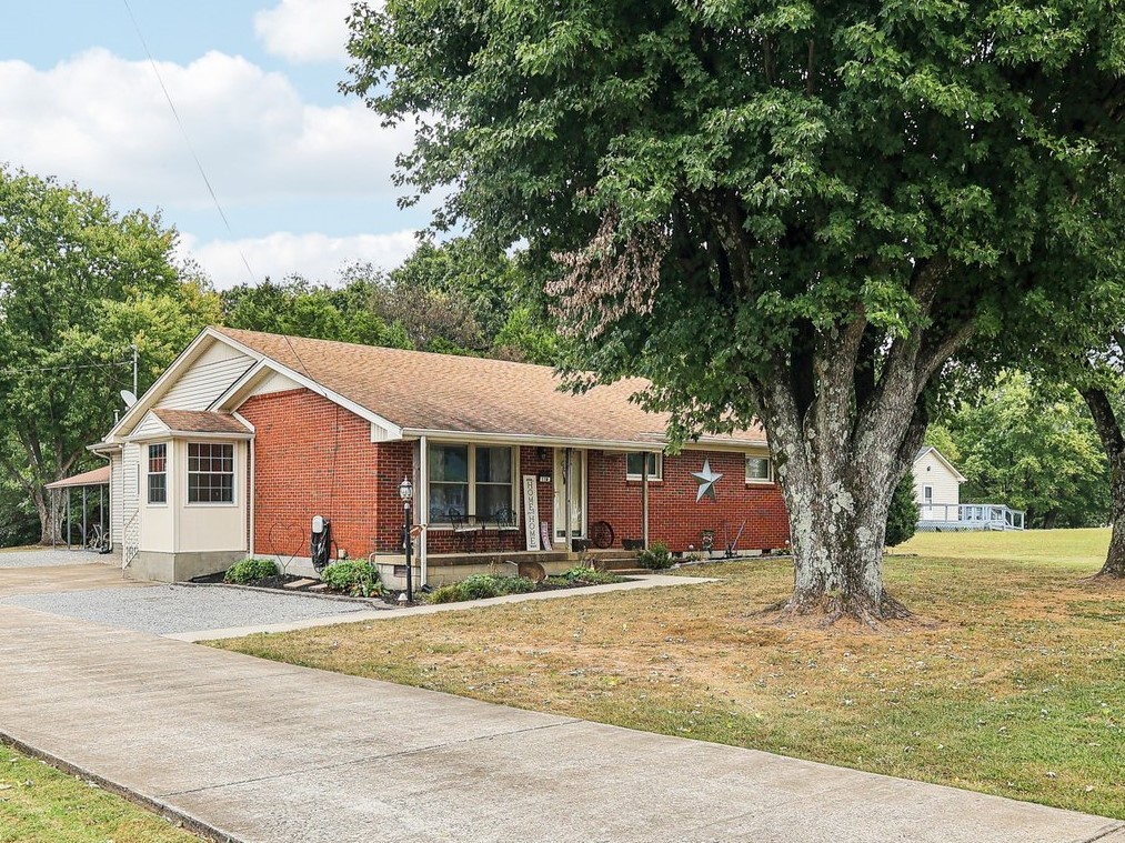 118 New Deal Potts Road Portland, TN 37148 - Photo 1 of 44 a front view of a house with a yard and large trees