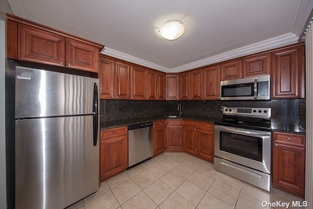 a kitchen with stainless steel appliances granite countertop a refrigerator stove top oven a sink and dishwasher