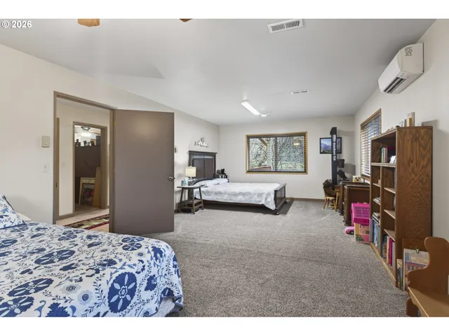 a bedroom with furniture and a flat screen tv