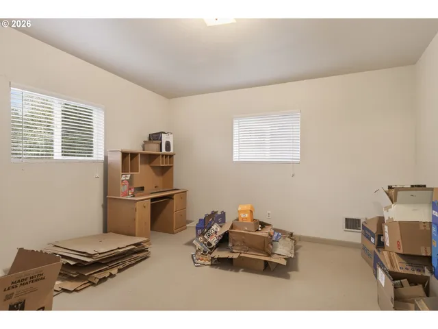 a kitchen with a refrigerator and a stove top oven