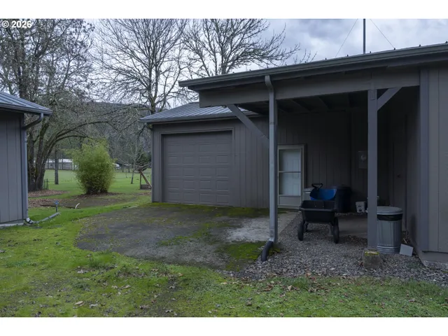 a backyard of a house with table and chairs