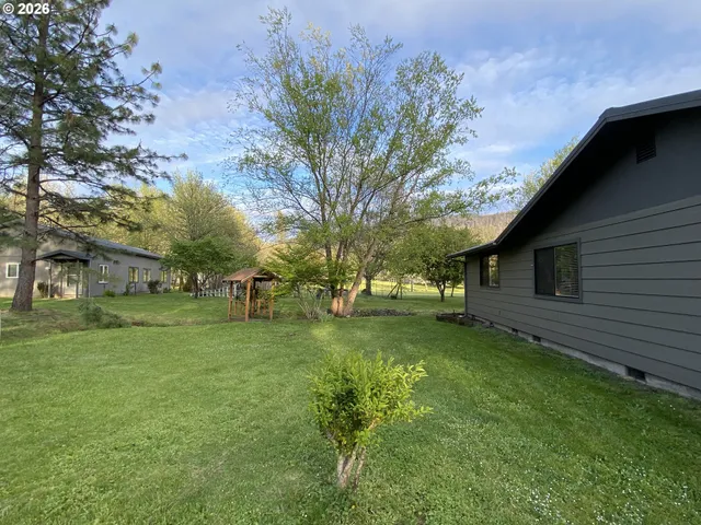 a backyard of a house with lots of green space