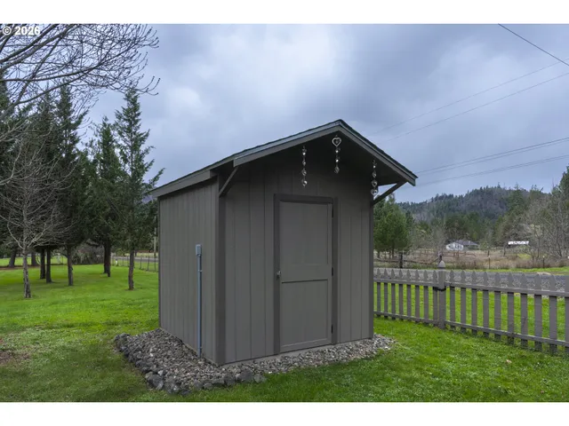 a view of a wooden fence with a bench in the background