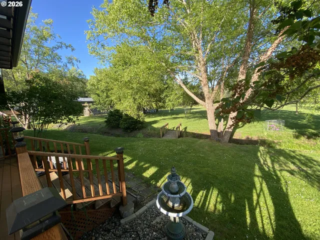 a view of a wooden deck and a garden