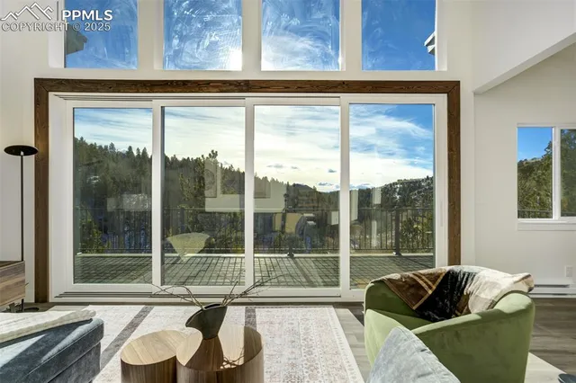 a living room with furniture and large windows