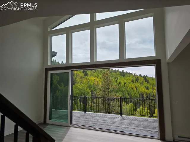 a view of a glass door with a yard from a window