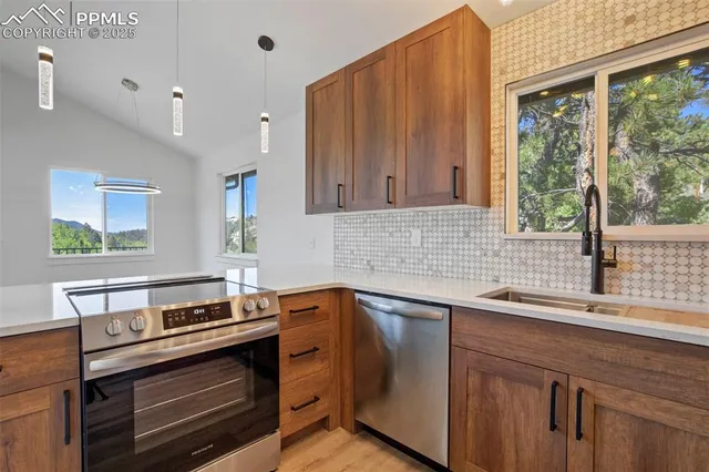 a kitchen with a sink stove and microwave