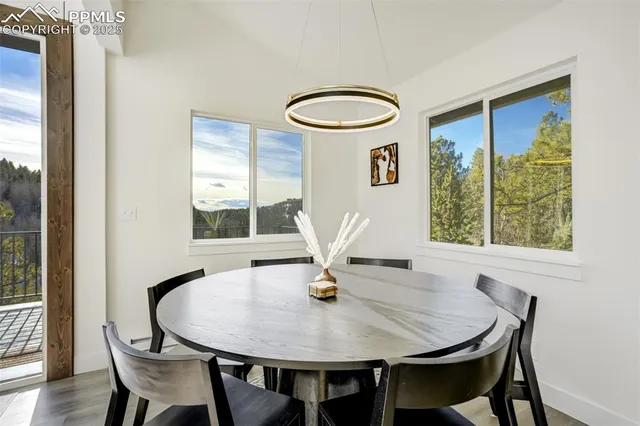 a living room with furniture a flat screen tv and a large window