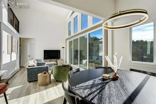 a kitchen with stainless steel appliances kitchen island granite countertop a sink a stove and chairs