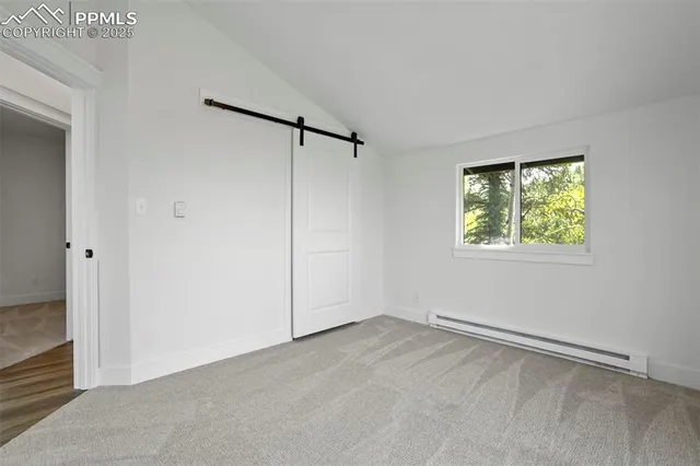 an empty room with windows and closet