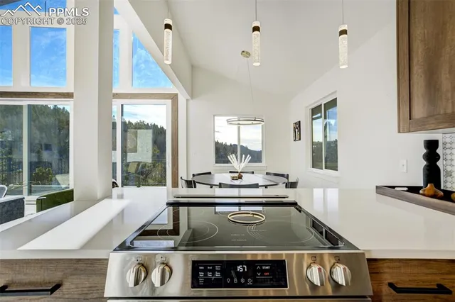 a open kitchen with a sink and wooden floor