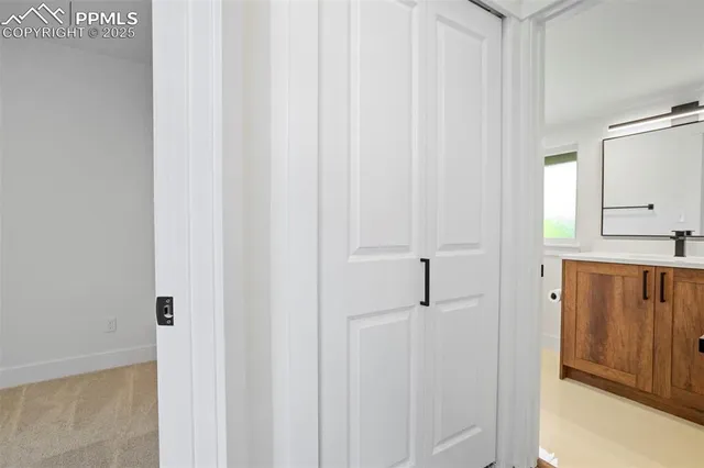 a bathroom with a sink a toilet a mirror and shower