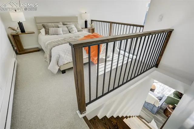 a bedroom with a bed and a night stand